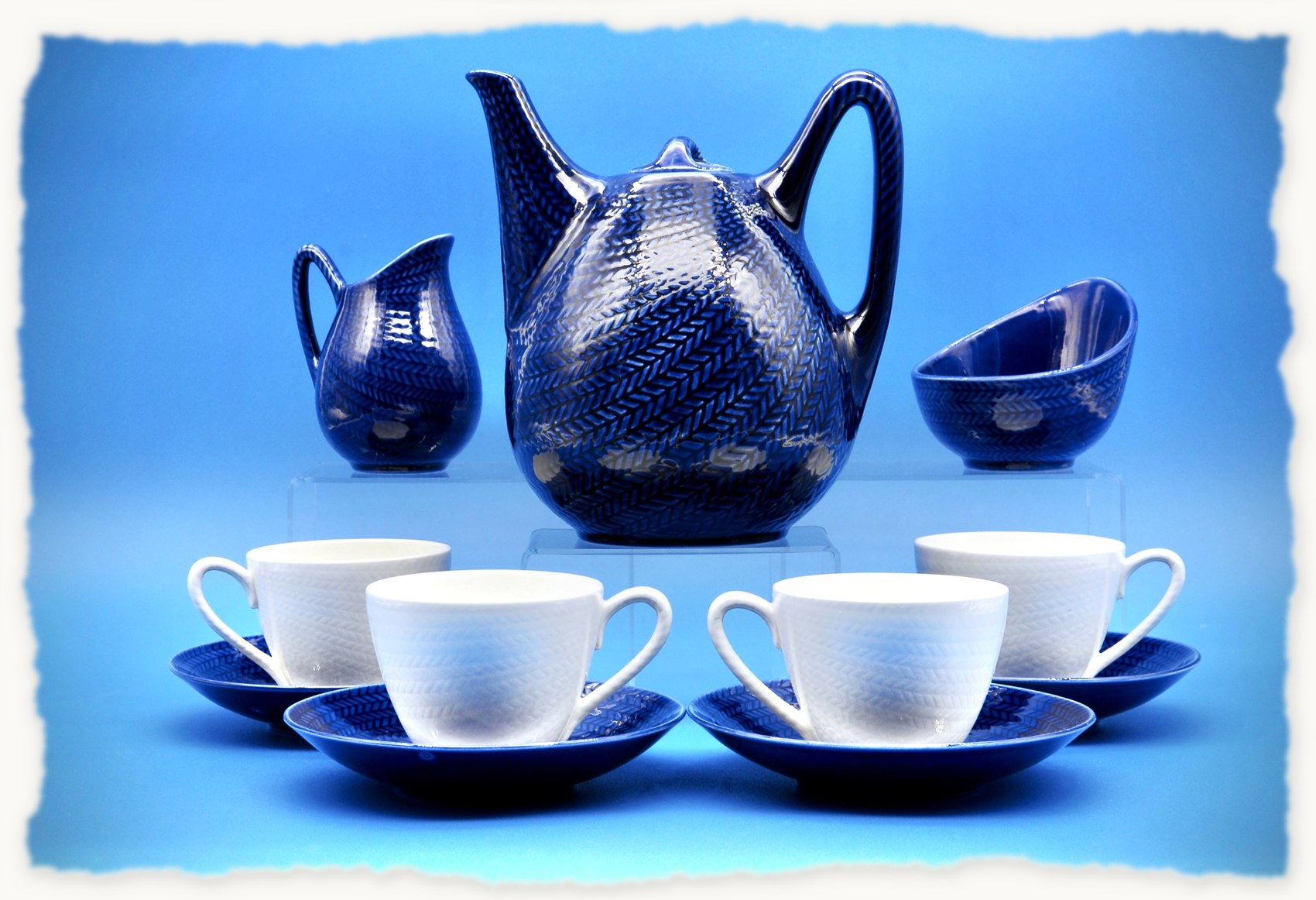 The full Blå Eld tea service: teapot, creamer, sugar bowl, and four cups with saucers